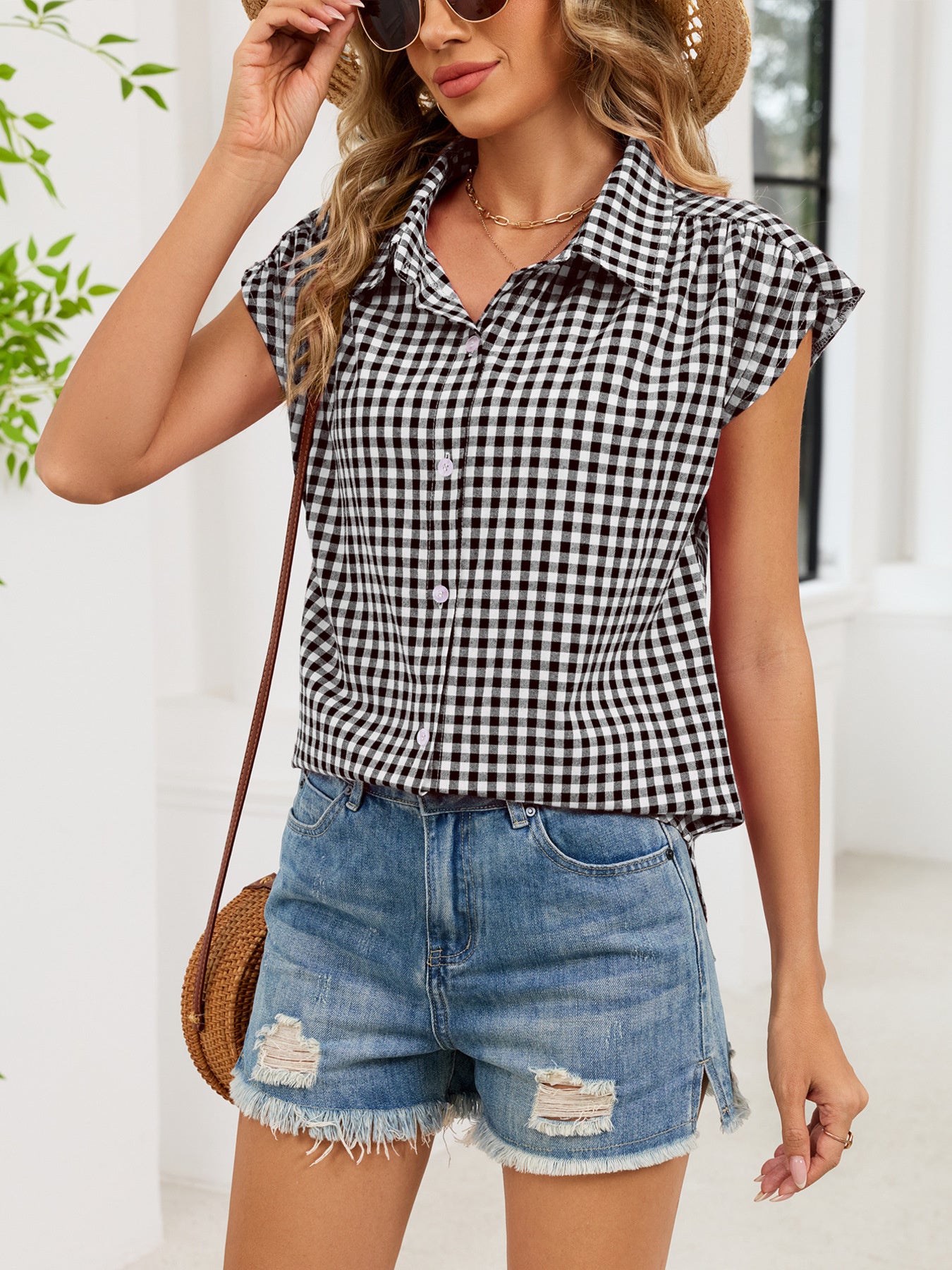 Black plaid cap-sleeve button-up shirt worn with light-wash denim shorts