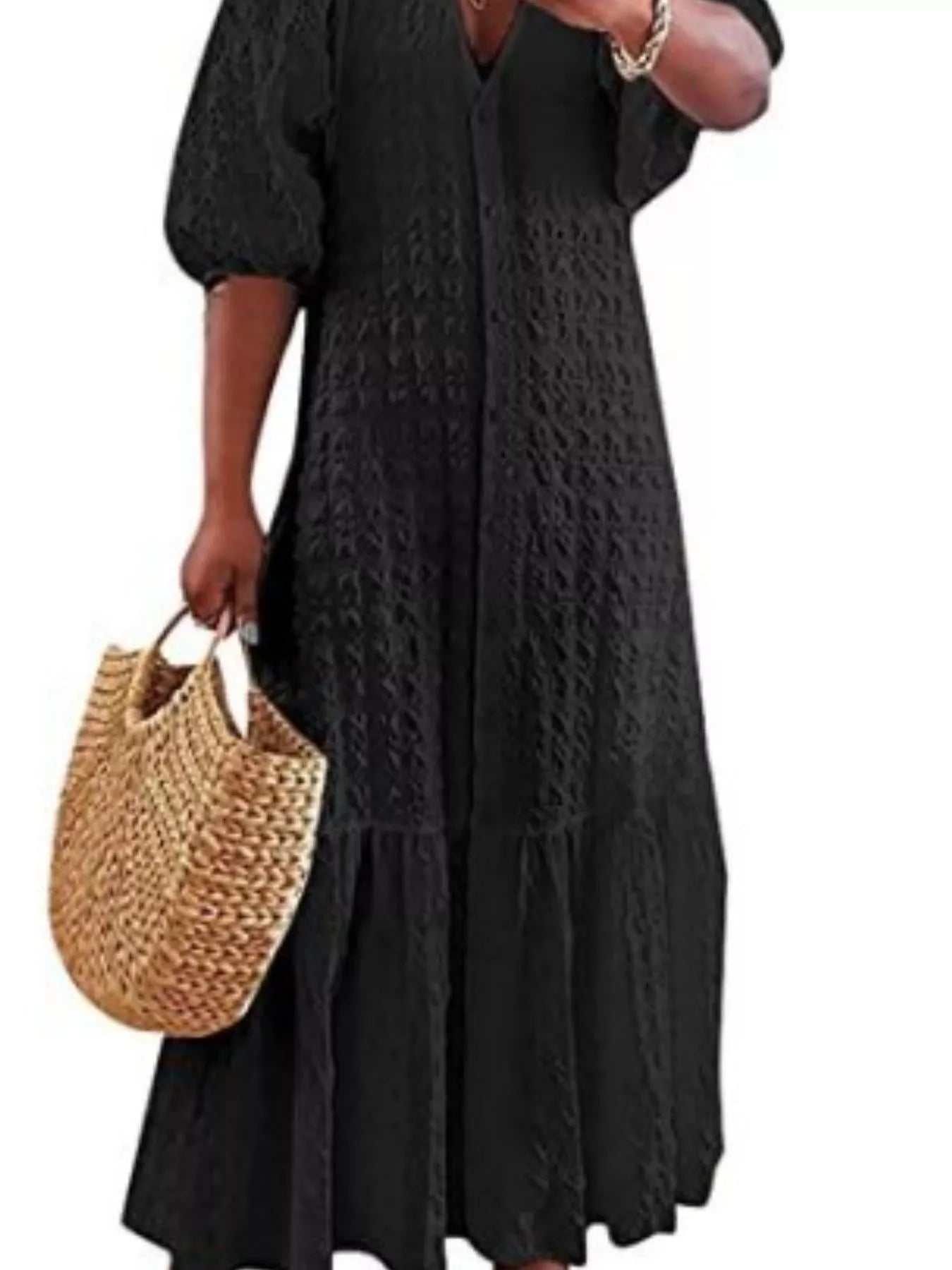 Black textured maxi dress with V-neck and short puff sleeves, tiered hem