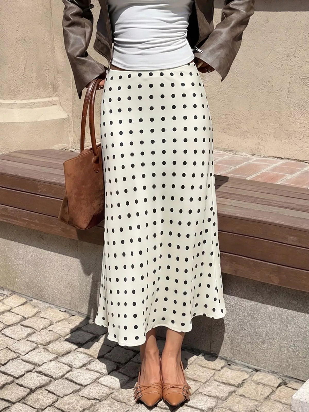 Cream polka dot midi skirt with black dots, high-rise waistband and flared mid-calf cut