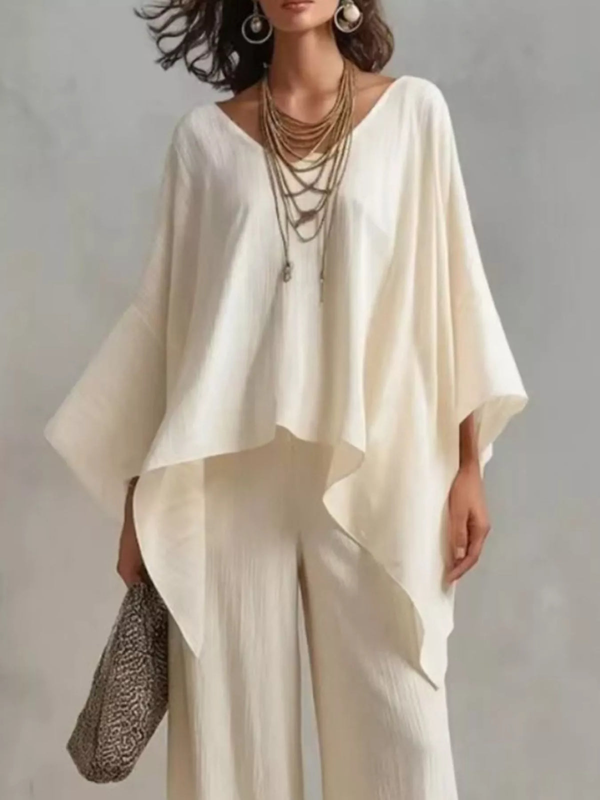 White V-neck top and wide-leg pants set with layered, draped sleeves and loose fit