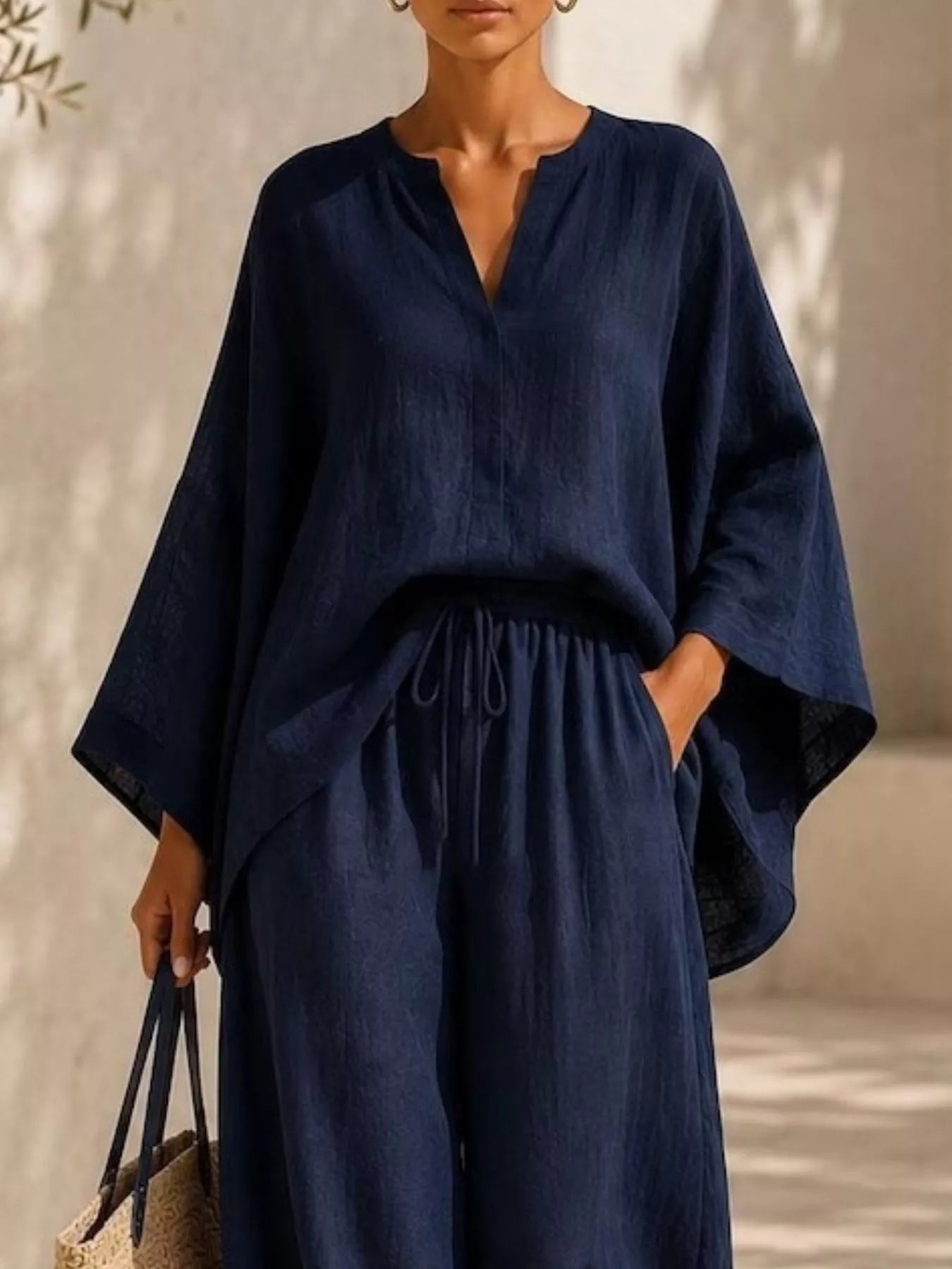 Plus-size notched long-sleeve top and wide-leg pants set in navy with V-neck and wide legs