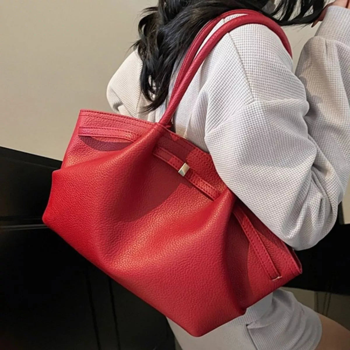Red PU leather shoulder bag with wide top handles and front flap with small clasp