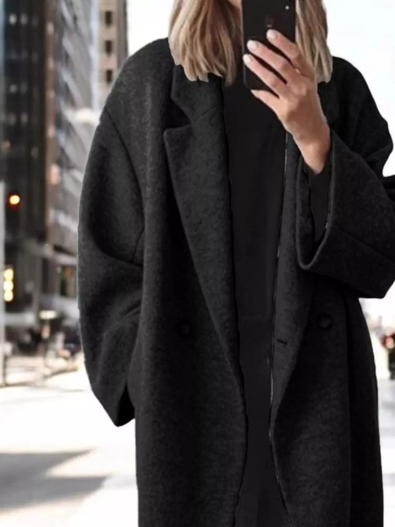 Black longline wool-blend coat with wide sleeves, notch lapels, and buttoned front