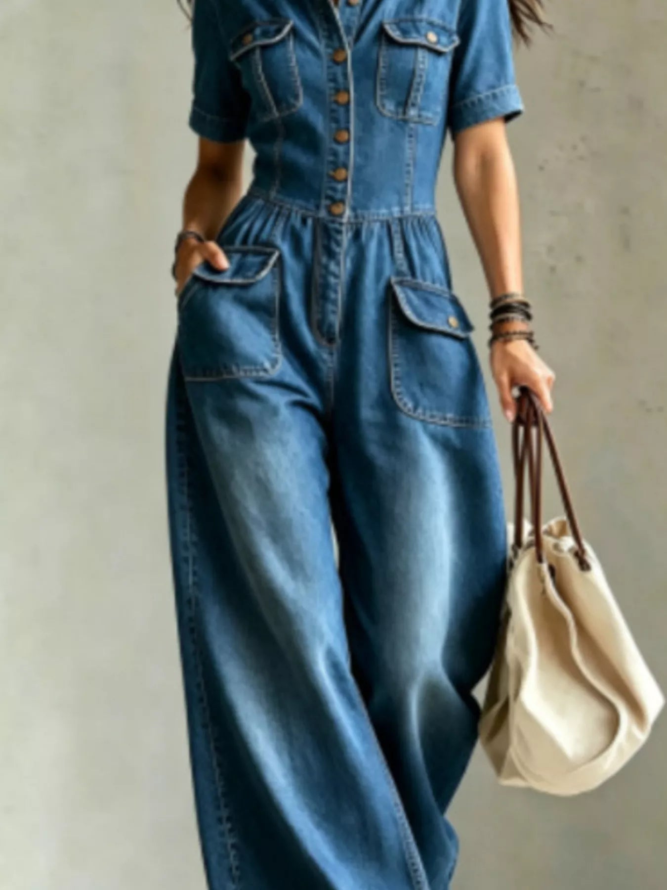 Dark blue denim wide-leg jumpsuit with chest pockets and side seam pockets