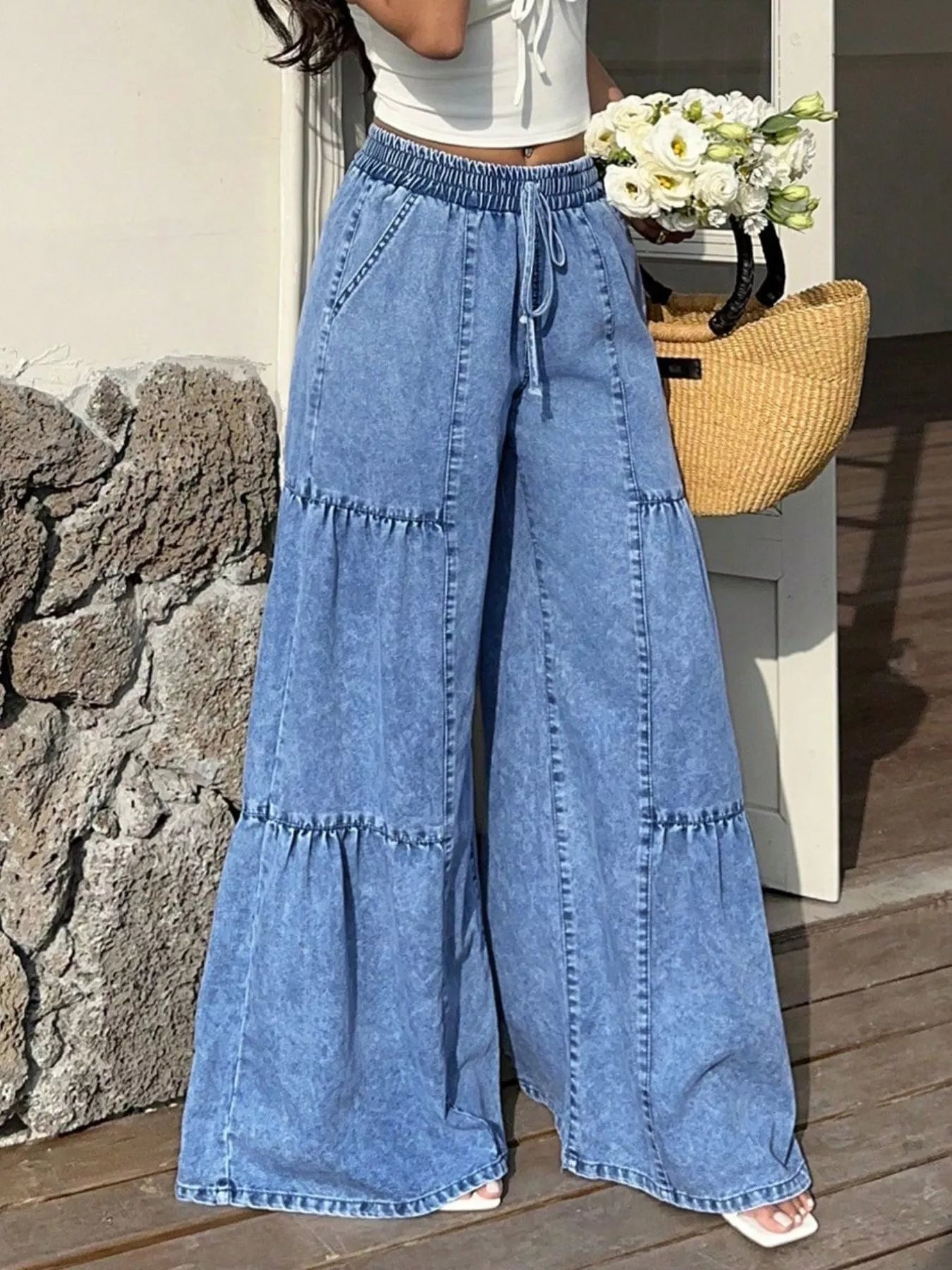 Blue wide-leg tiered jeans with elastic drawstring waist and layered denim ruffles