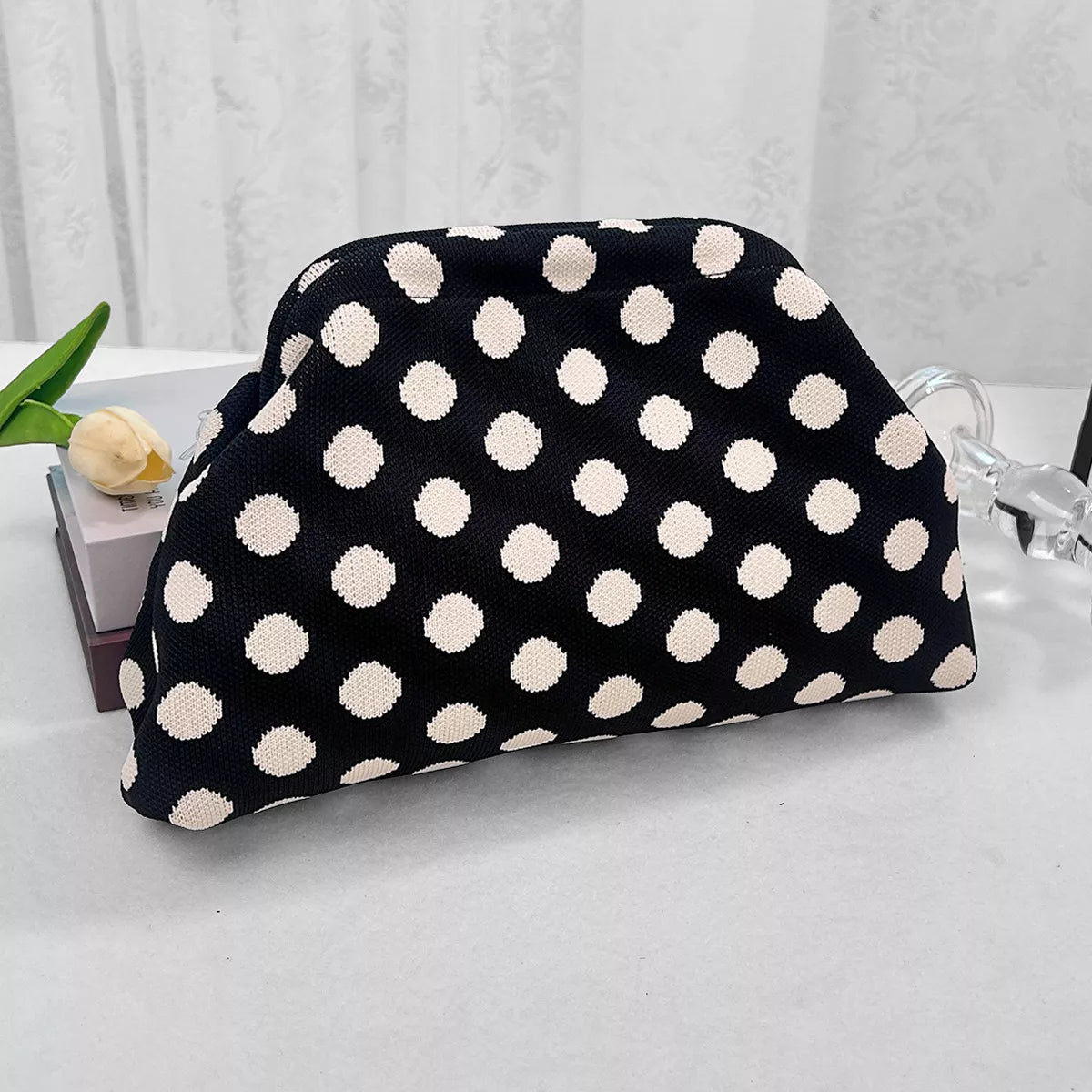 Black knit polka-dot clutch with rounded top