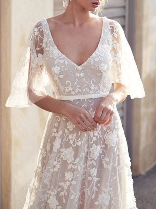 White lace V-neck dress with sheer flutter sleeves and waist sash