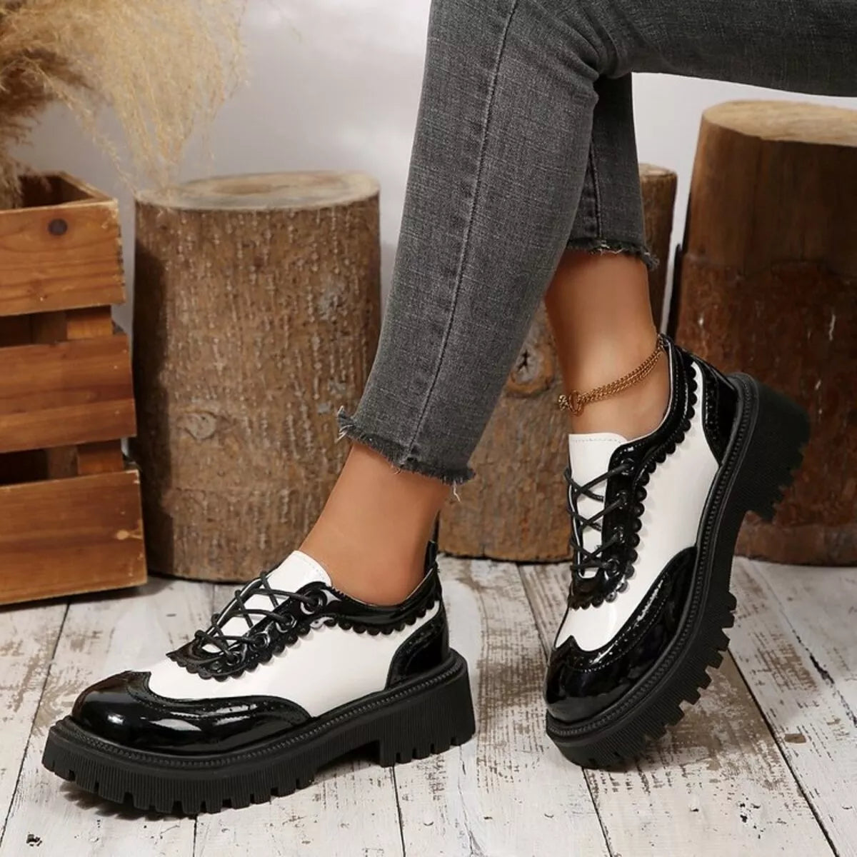 Platform loafers in white and black with lace-up front and chunky tread sole