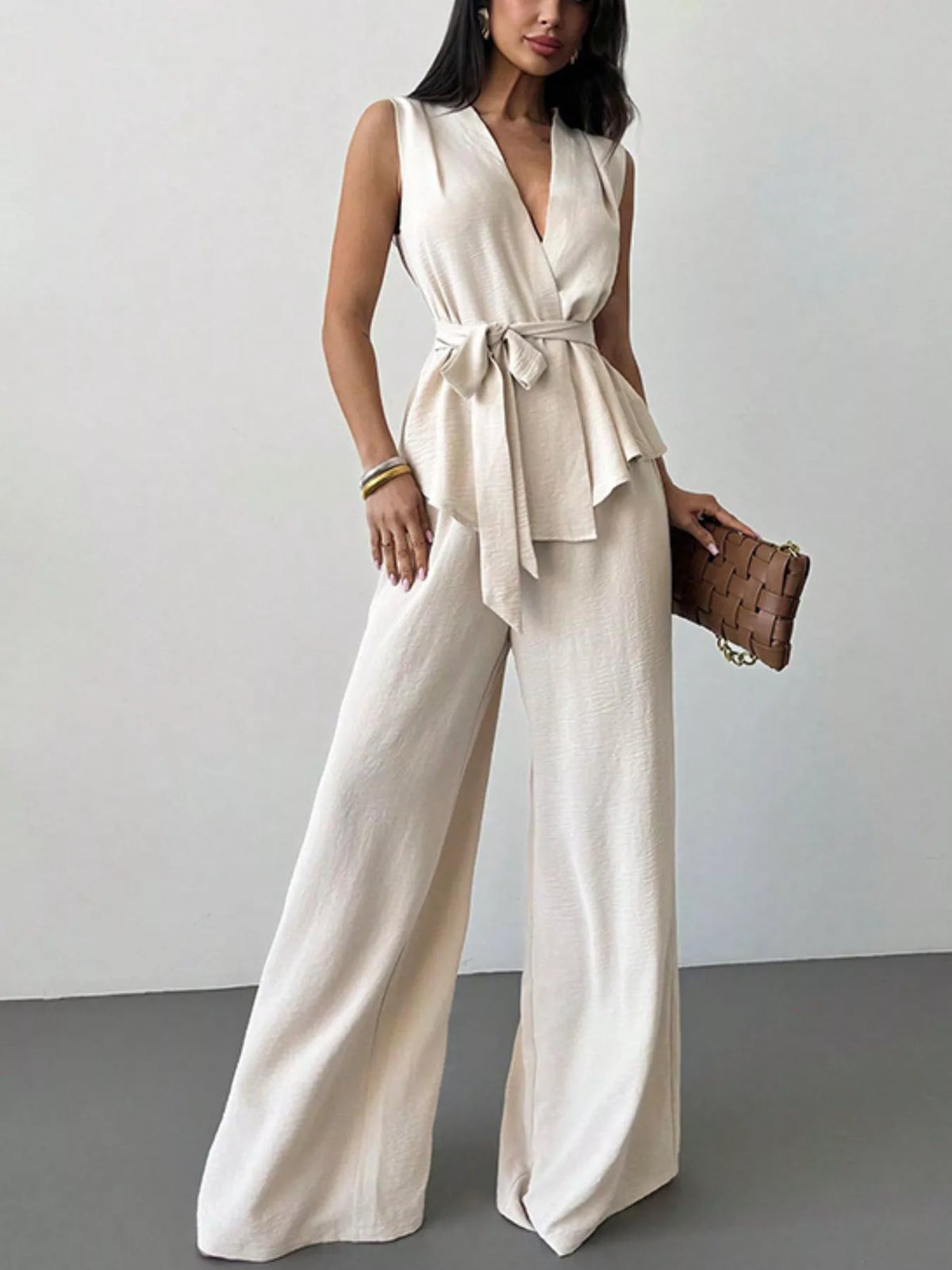 White sleeveless wrap top and wide-leg pants set, tied waist peplum, V-neck