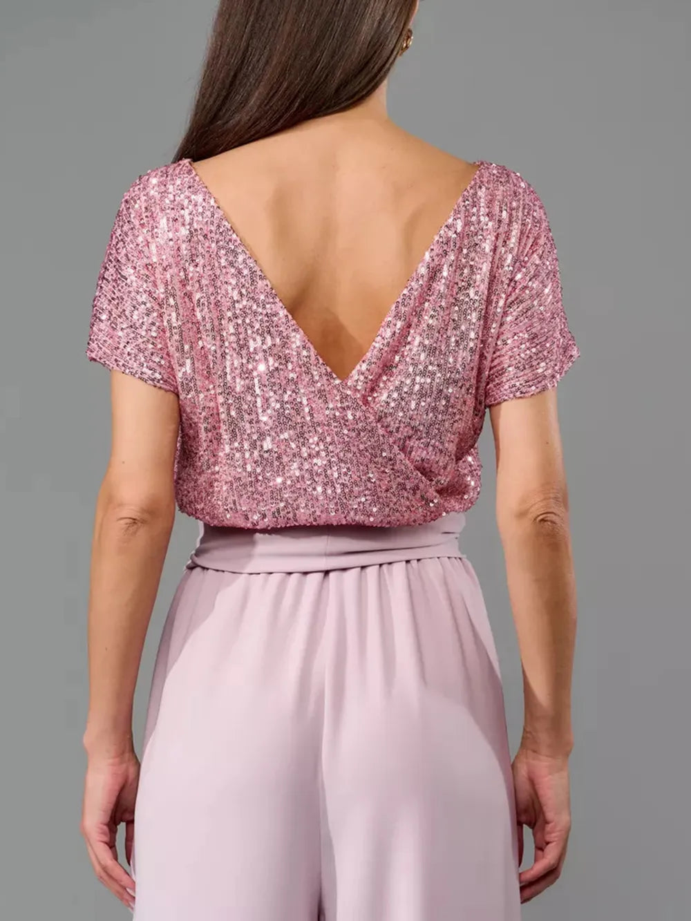 Dusty pink sequin V-back short-sleeve top with elastic waist and wide-leg pants.
