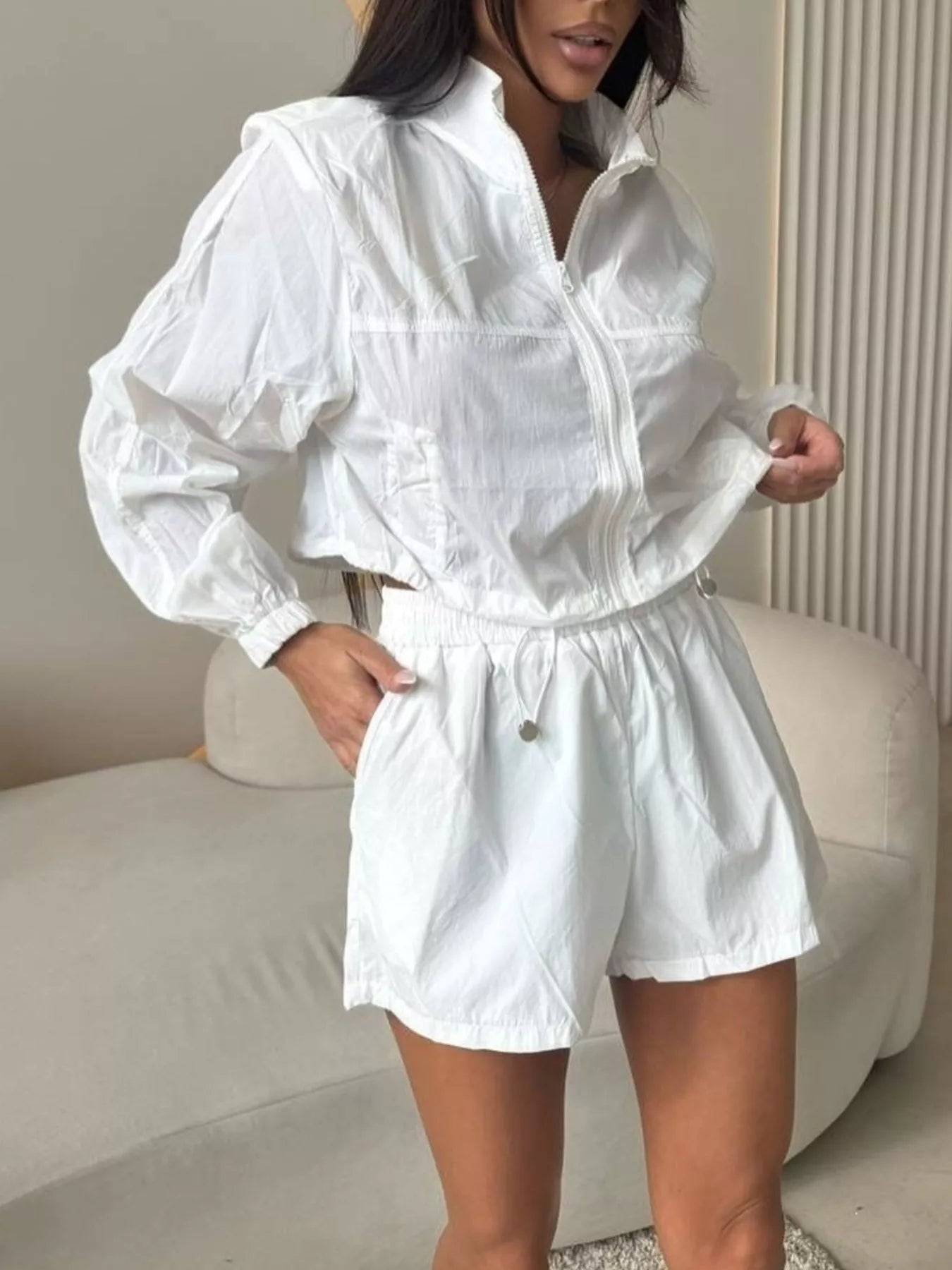 White zip-up long sleeve top with matching shorts, elastic waist and drawcord