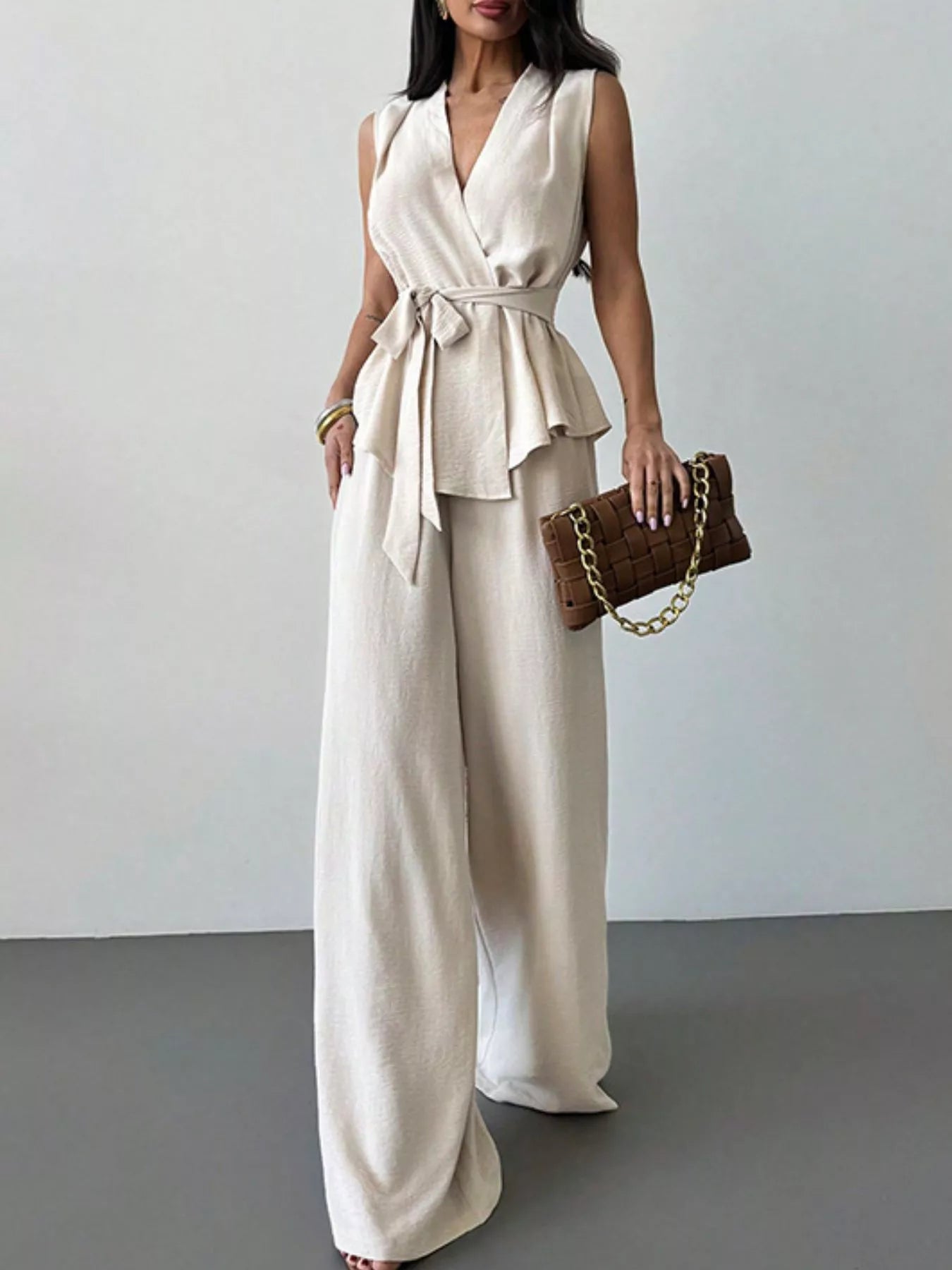 White sleeveless wrap top and wide-leg pants set, knotted tie at waist, wide legs