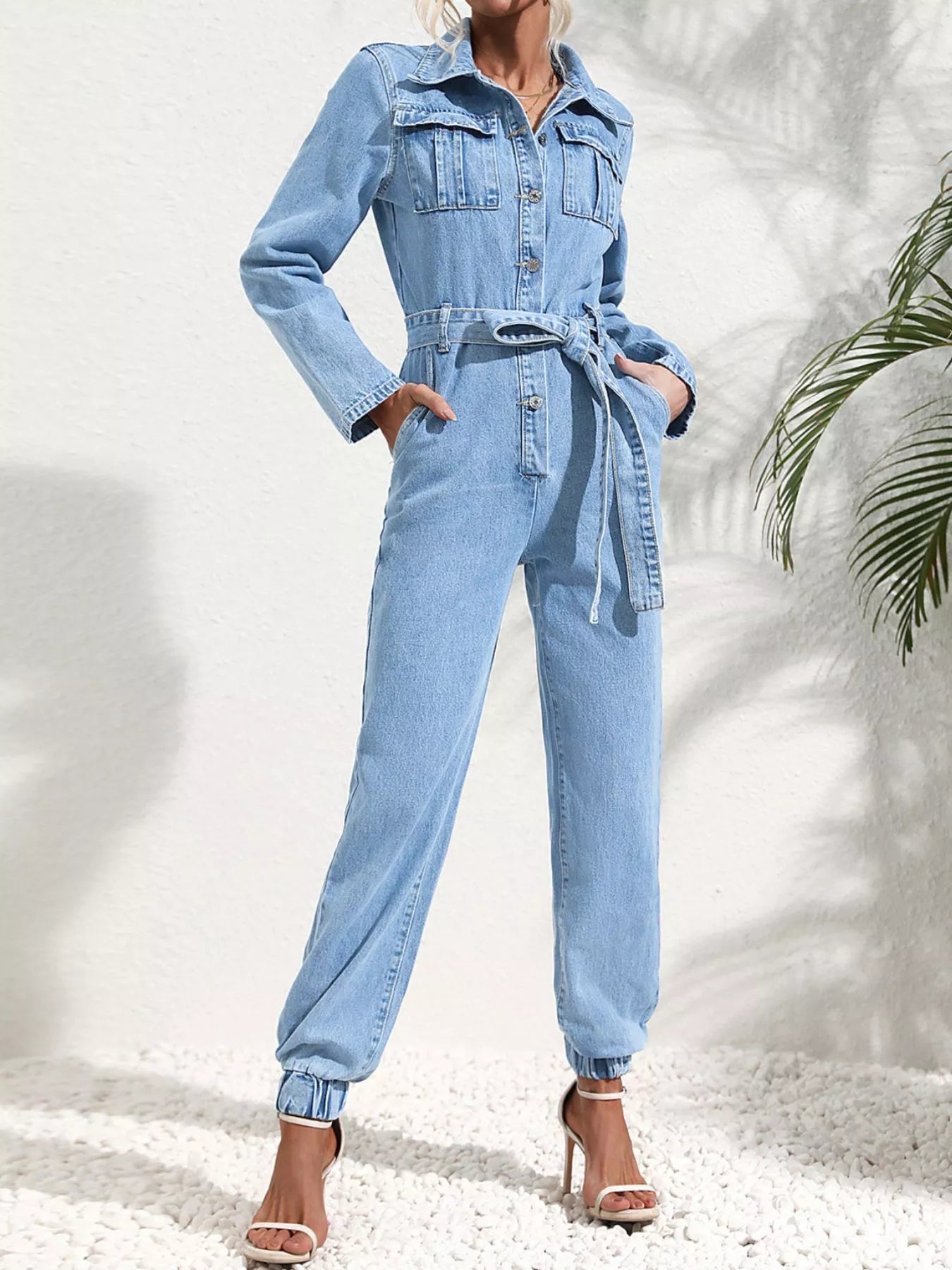 Medium blue denim button-front jumpsuit with waist tie belt and wide legs