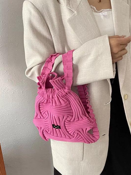 Rose red knitted backpack bag with drawstring top and black logo patch