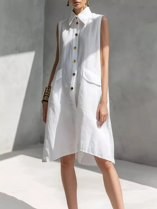 White sleeveless button-front dress with pointed collar and patch pockets, knee length