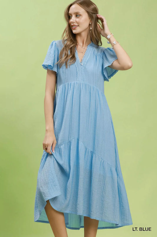 Light blue tiered midi dress with V-neck, flutter sleeves, and side pockets