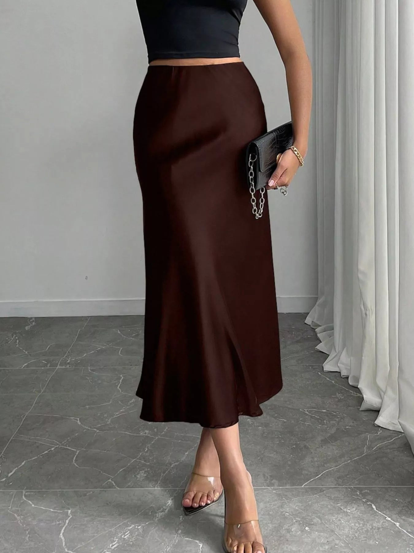 Satin midi skirt in brown, side view with sleek pencil fit and flowing hem