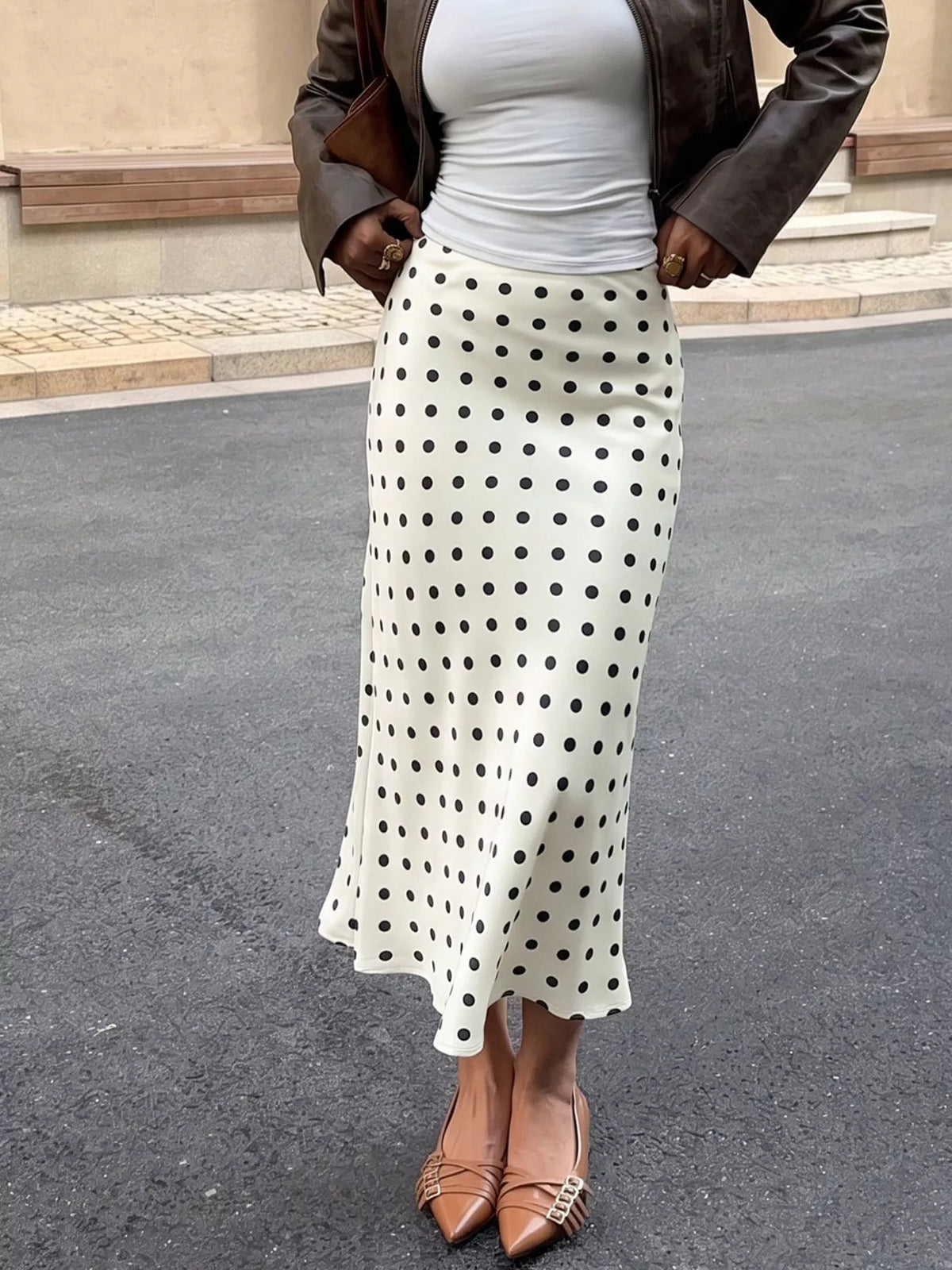 Cream polka dot midi skirt with black dots, fitted waist and gently flared A-line shape
