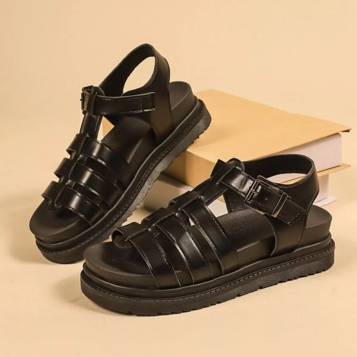 Black platform open-toe sandals with thick strap bands and adjustable buckle closure
