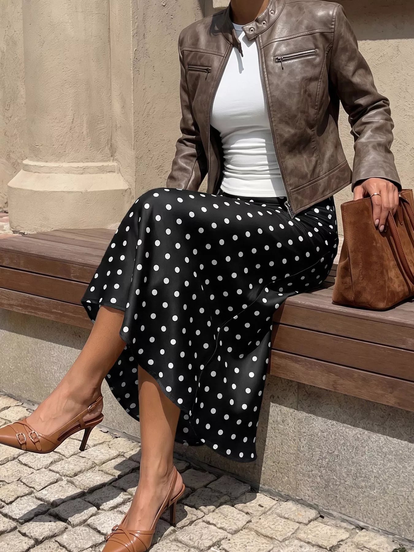 Black polka dot midi skirt with white dots and flowing A-line shape