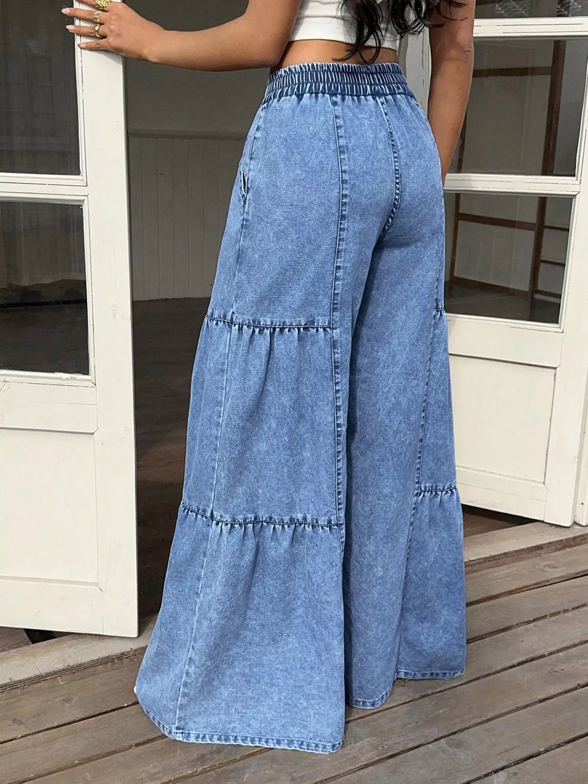 Blue wide-leg tiered denim jeans with elastic waistband and drawstring tie