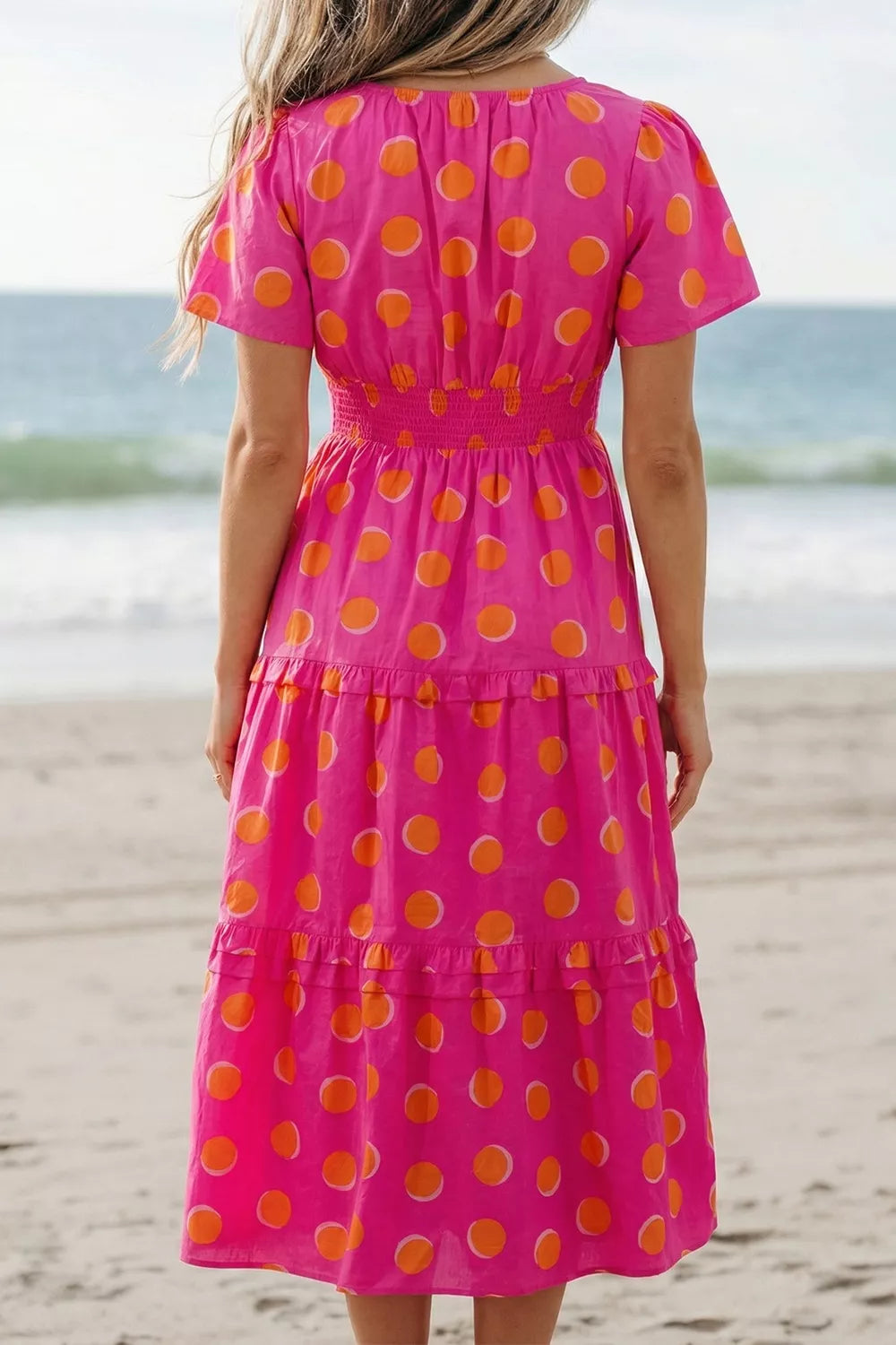 Hot pink polka dot tiered midi dress with smocked back yoke and short sleeves