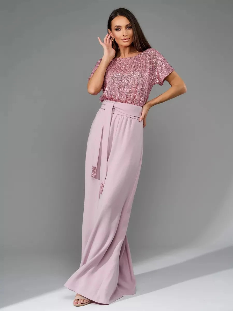 Dusty pink sequin short-sleeve jumpsuit with gathered waist and wide-leg pants.