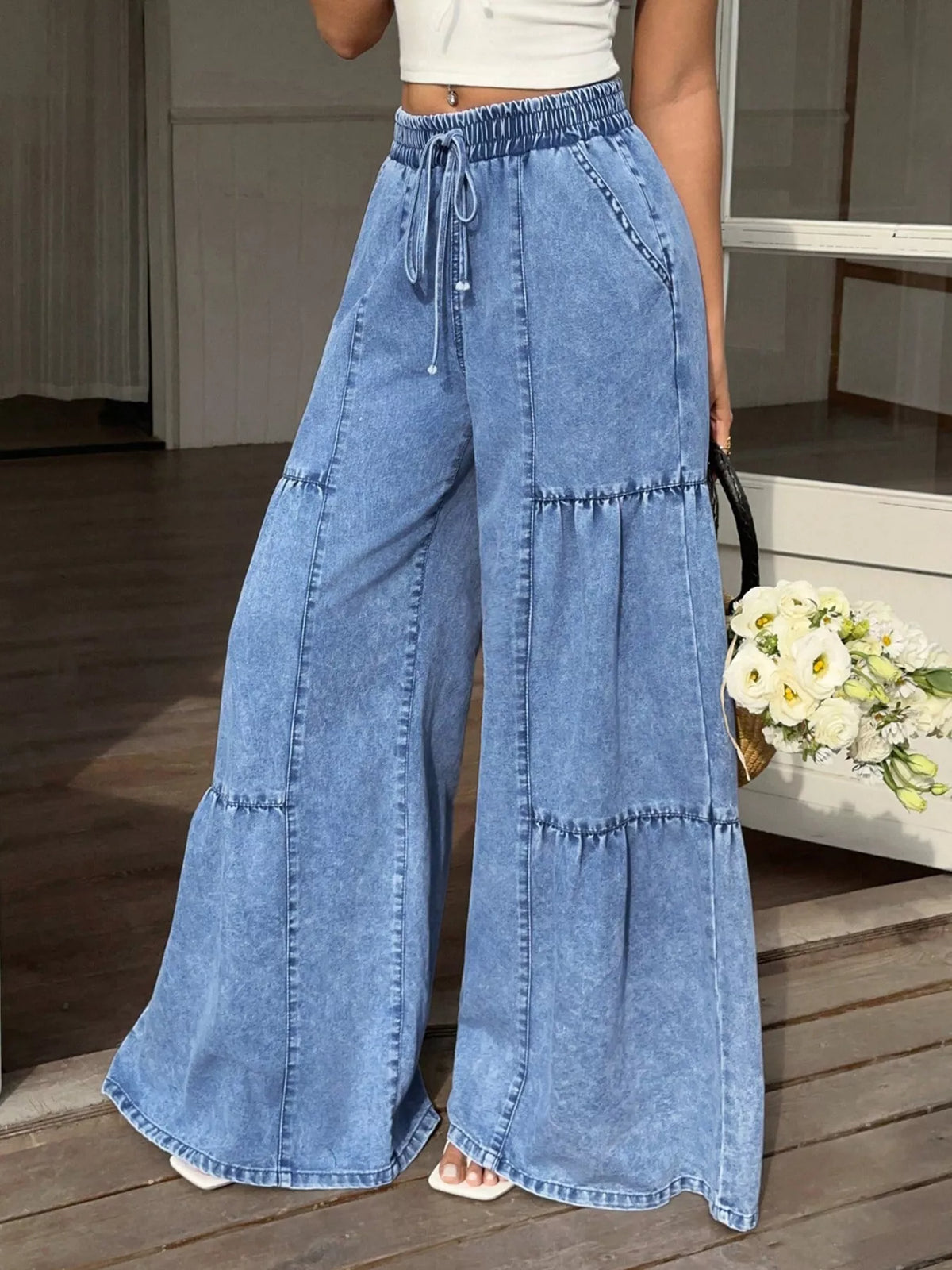 Blue wide-leg tiered jeans with elastic waistband and drawstring, side pockets