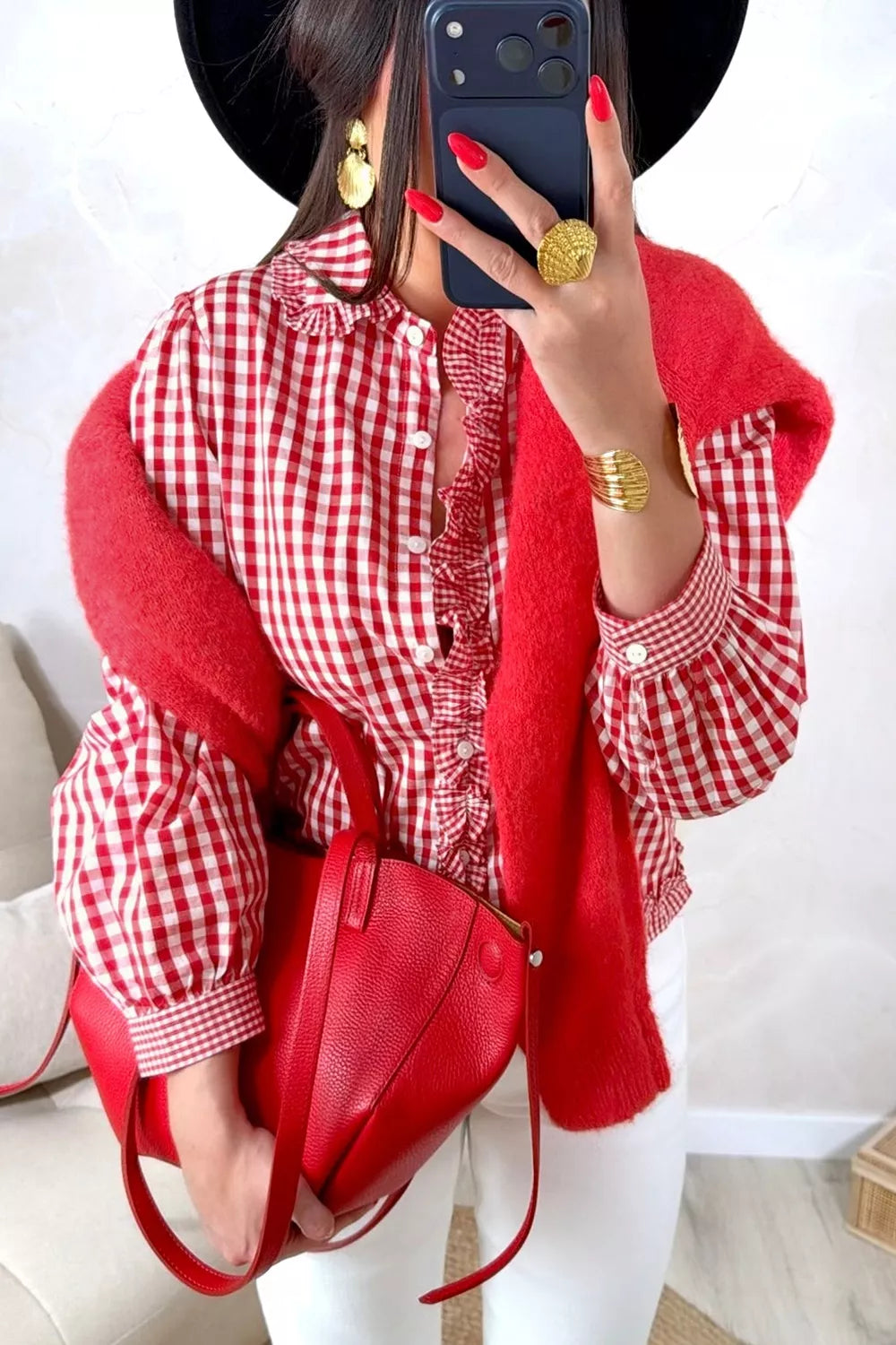 Pink and white plaid button-down shirt with ruffled front hem and cuffs