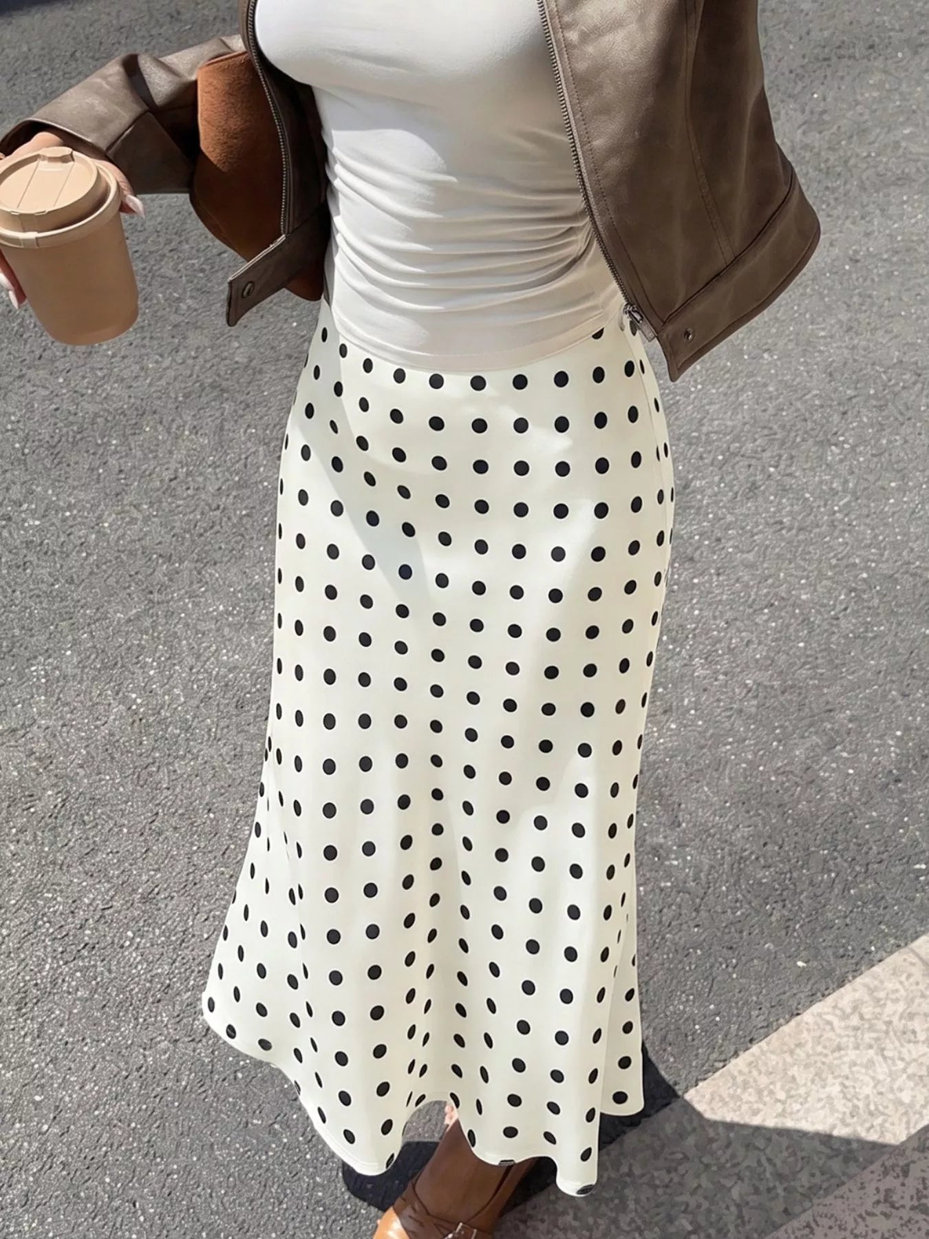 Cream polka dot midi skirt with black dots, smooth waistband and flowing A-line hem