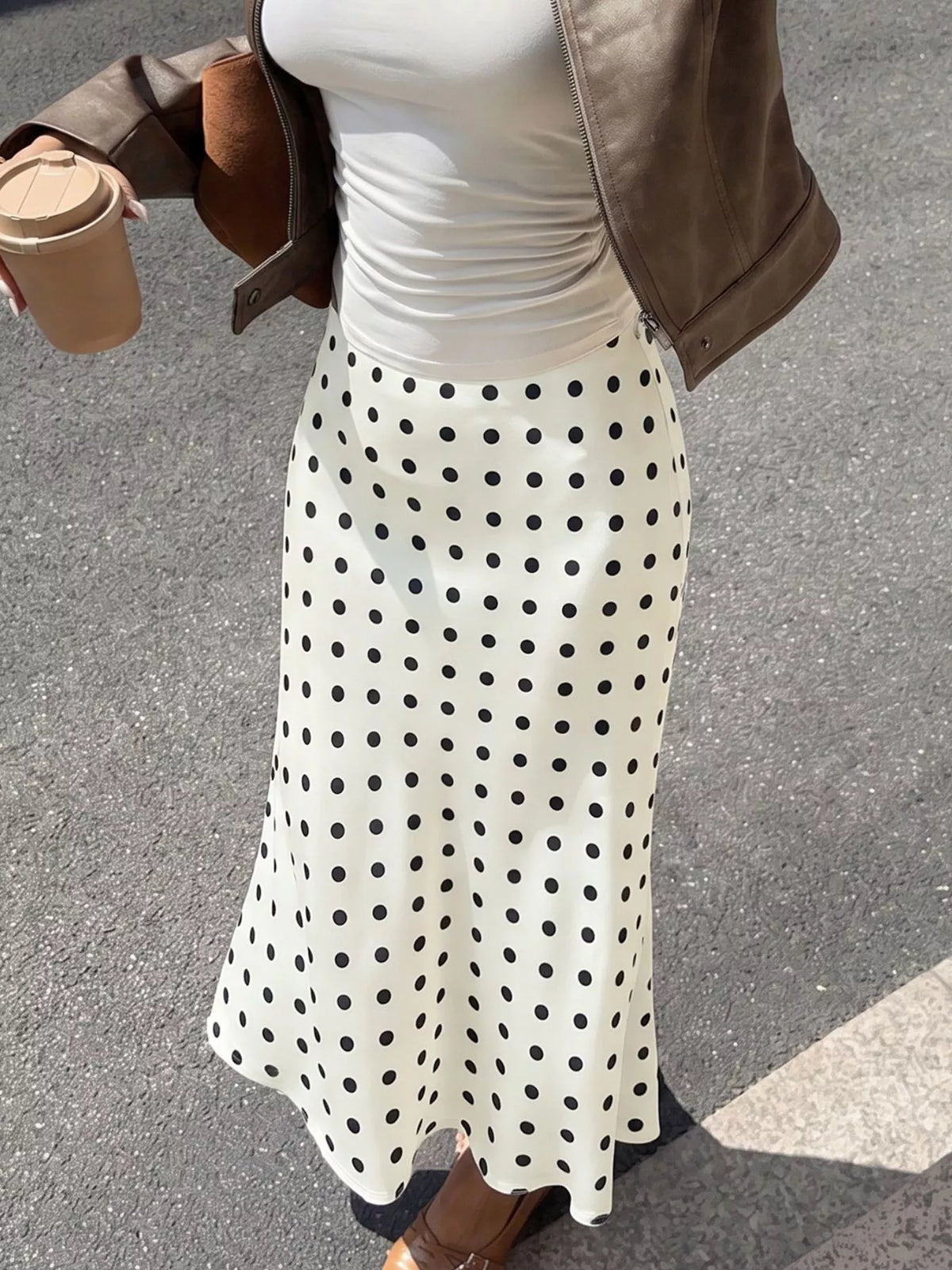 Cream polka dot midi skirt with black dots, smooth waistband and flowing A-line hem