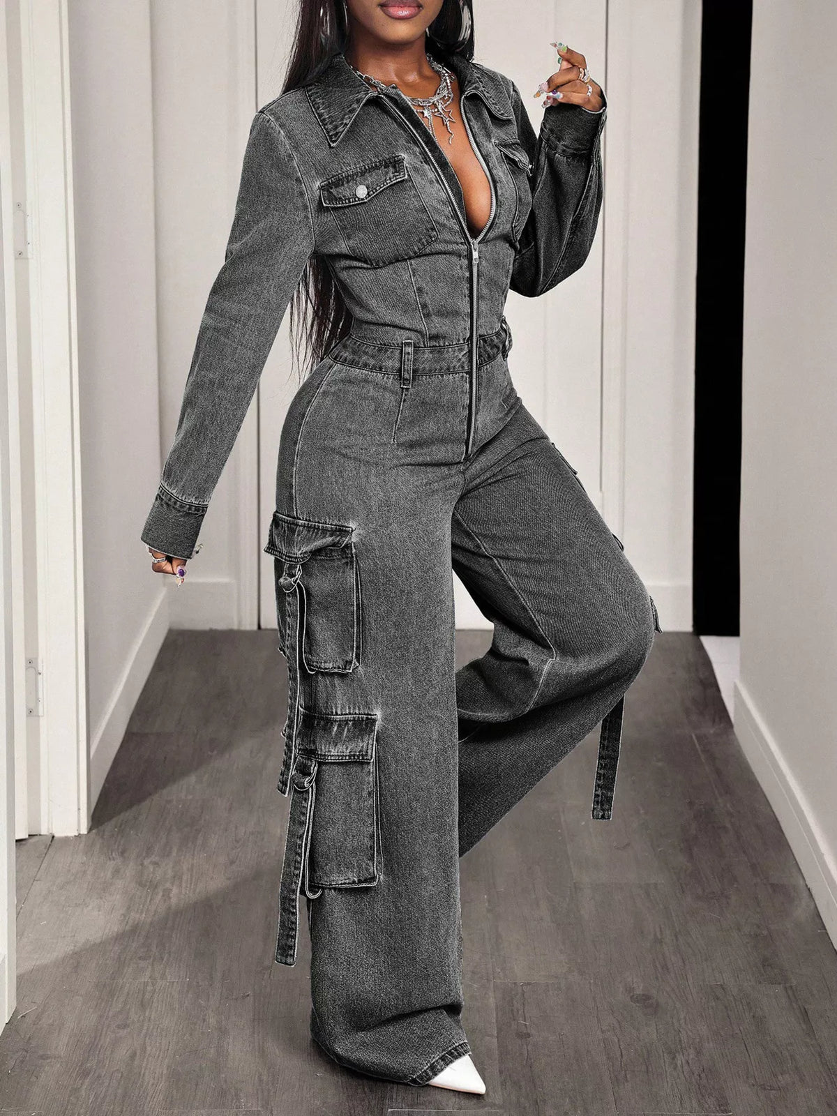Gray denim zip-front cargo jumpsuit with side utility pockets and relaxed wide-leg legs