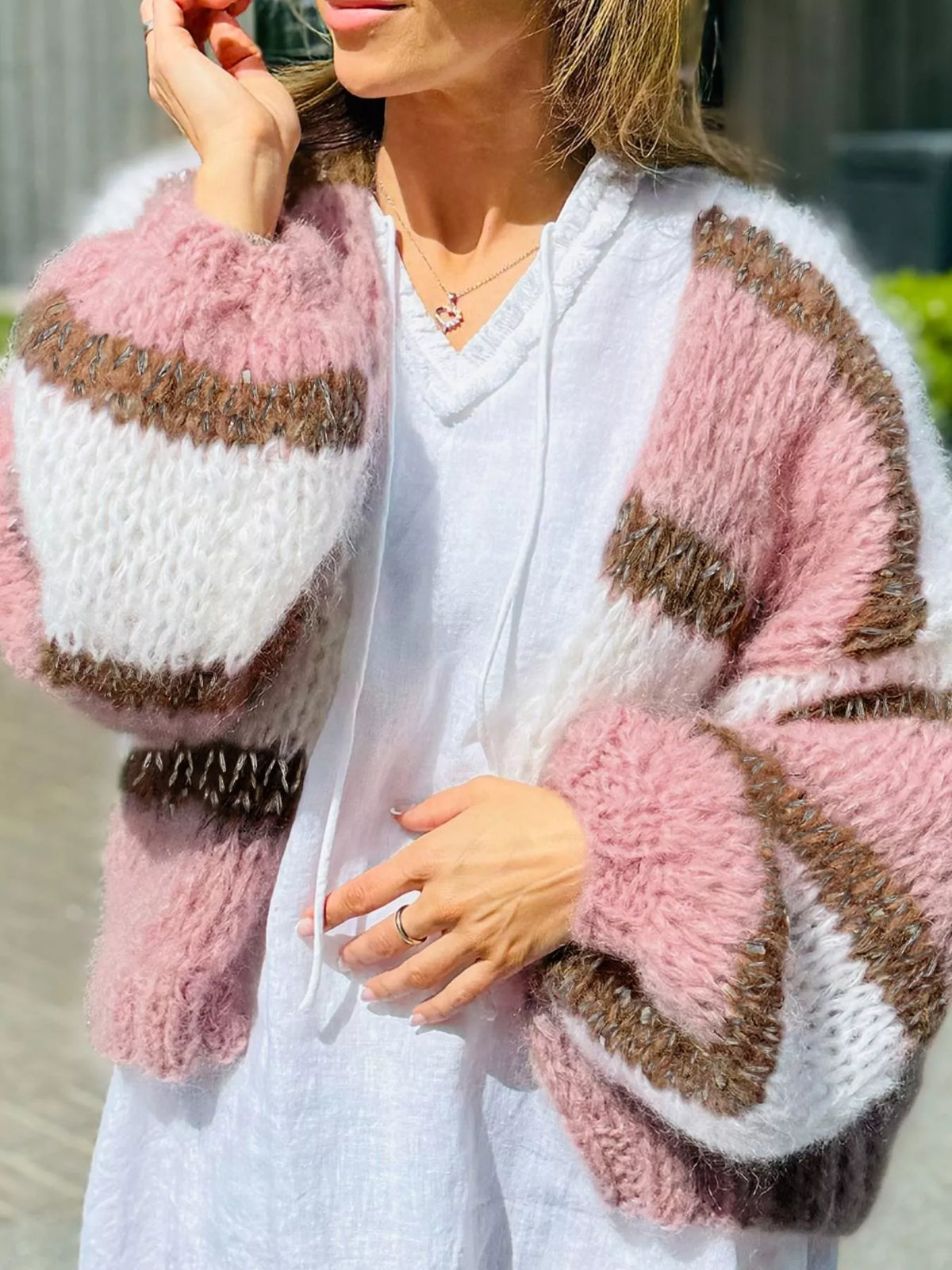 Dusty pink, white, and olive-brown striped open-front cardigan with long sleeves