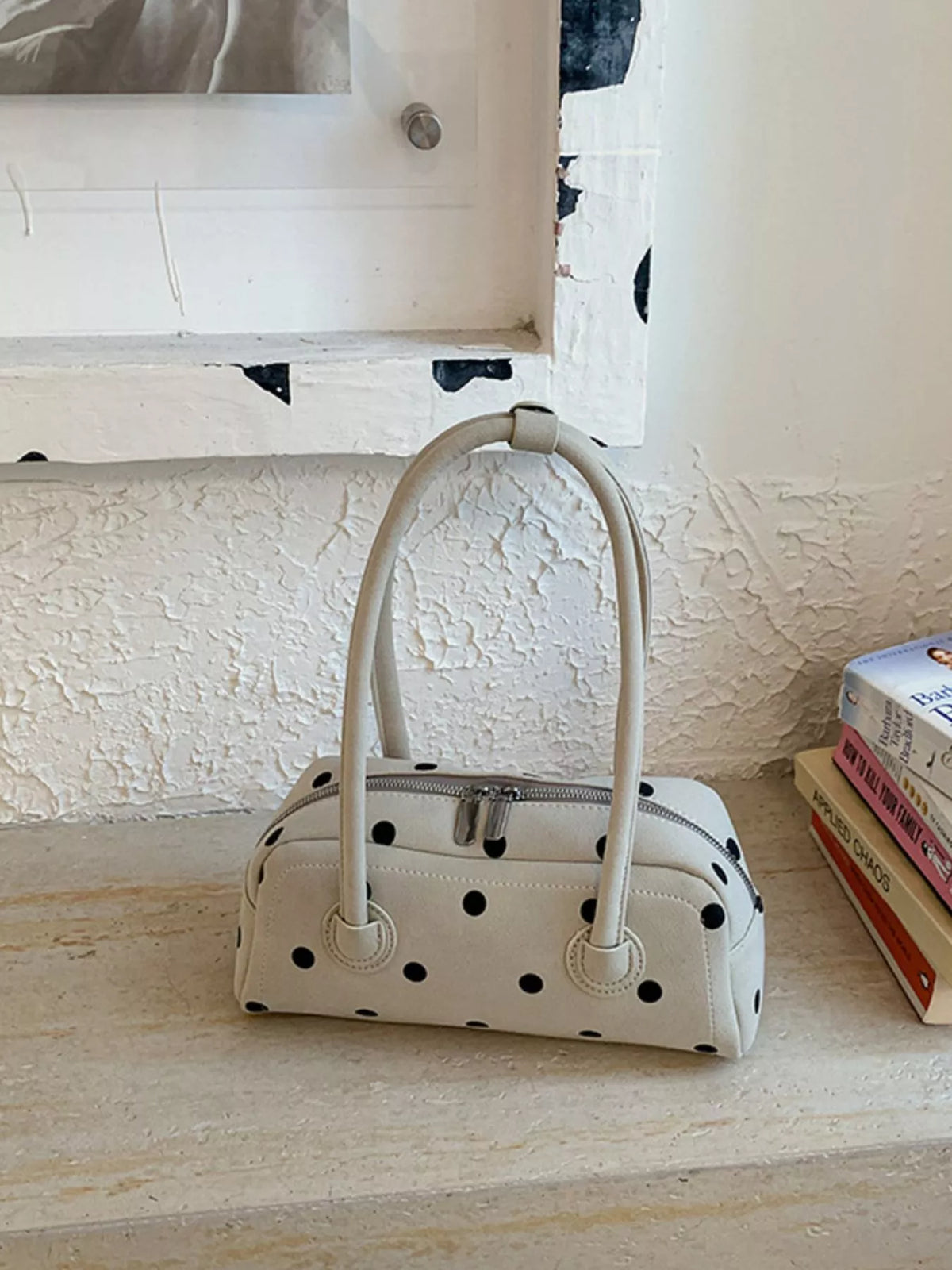 Off-white polka dot shoulder bag with zip top and two rounded handle loops