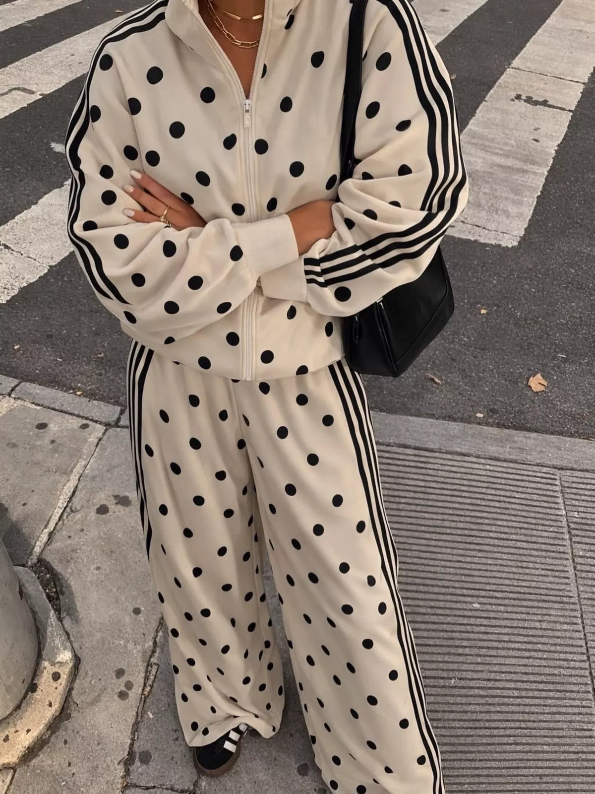 White polka-dot zip jacket and pants set with black vertical stripe accents
