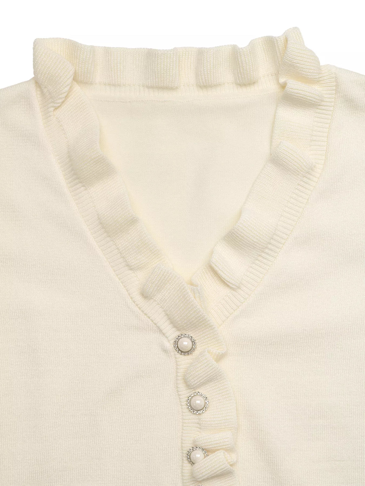 Close-up: Cream V-neck knit top with ruffled trim and small pearl-look buttons
