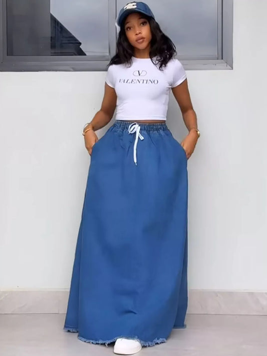Blue denim maxi skirt with elastic drawstring waist and raw frayed hem