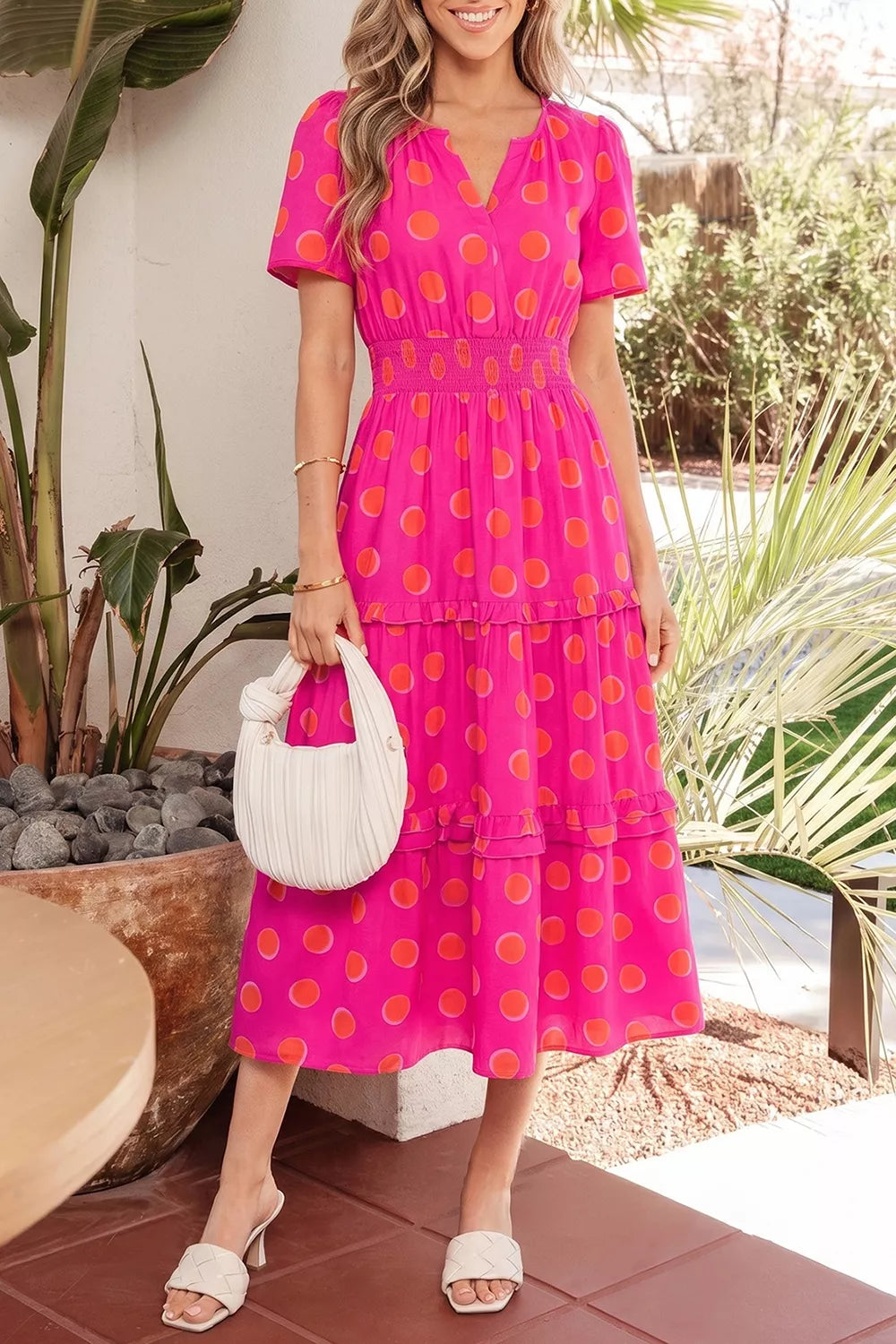 Hot pink polka dot tiered midi dress with V-neck and smocked waist, short sleeves