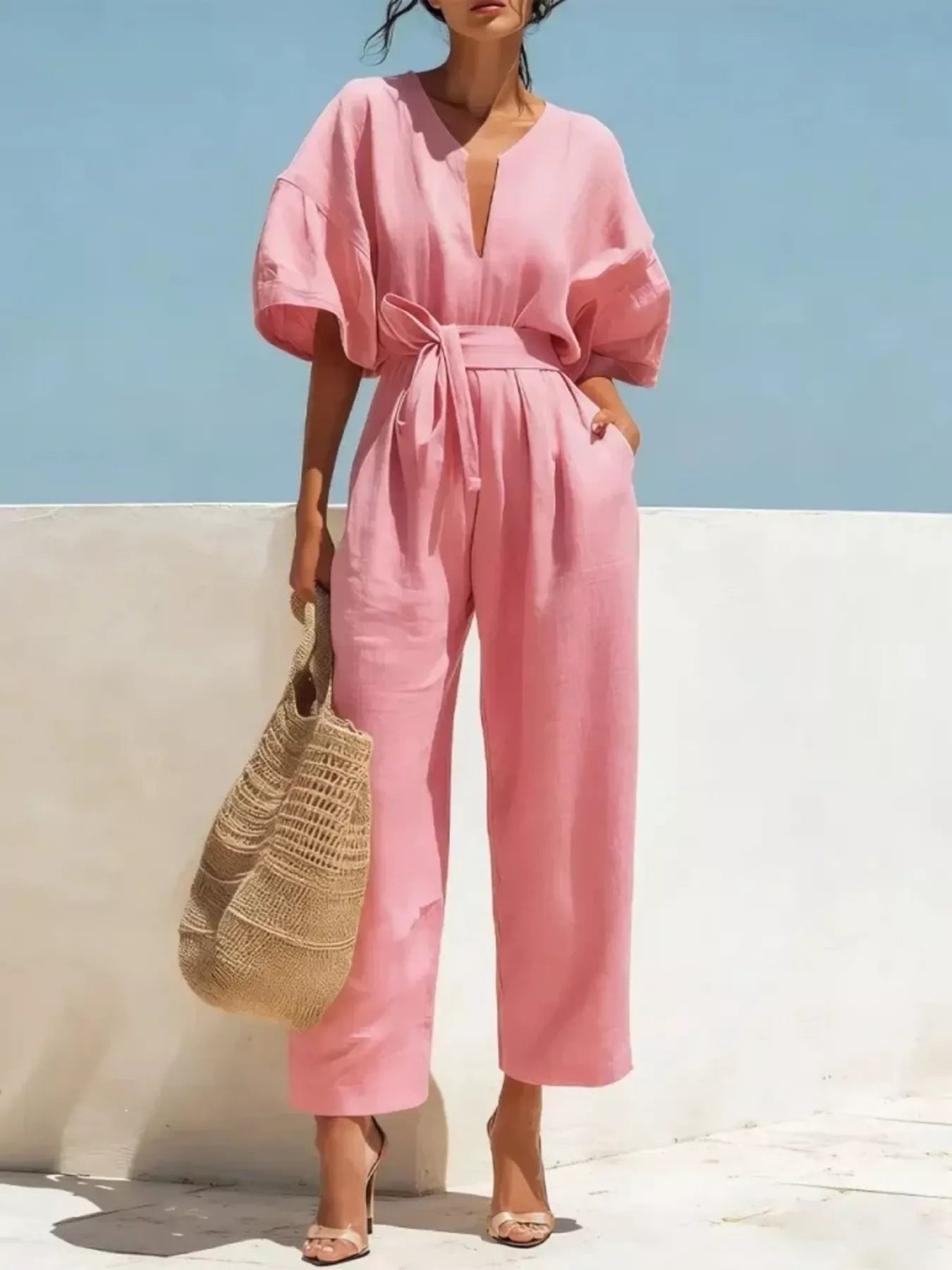 Pink tie-waist wide-leg jumpsuit with V-neck and short puff sleeves