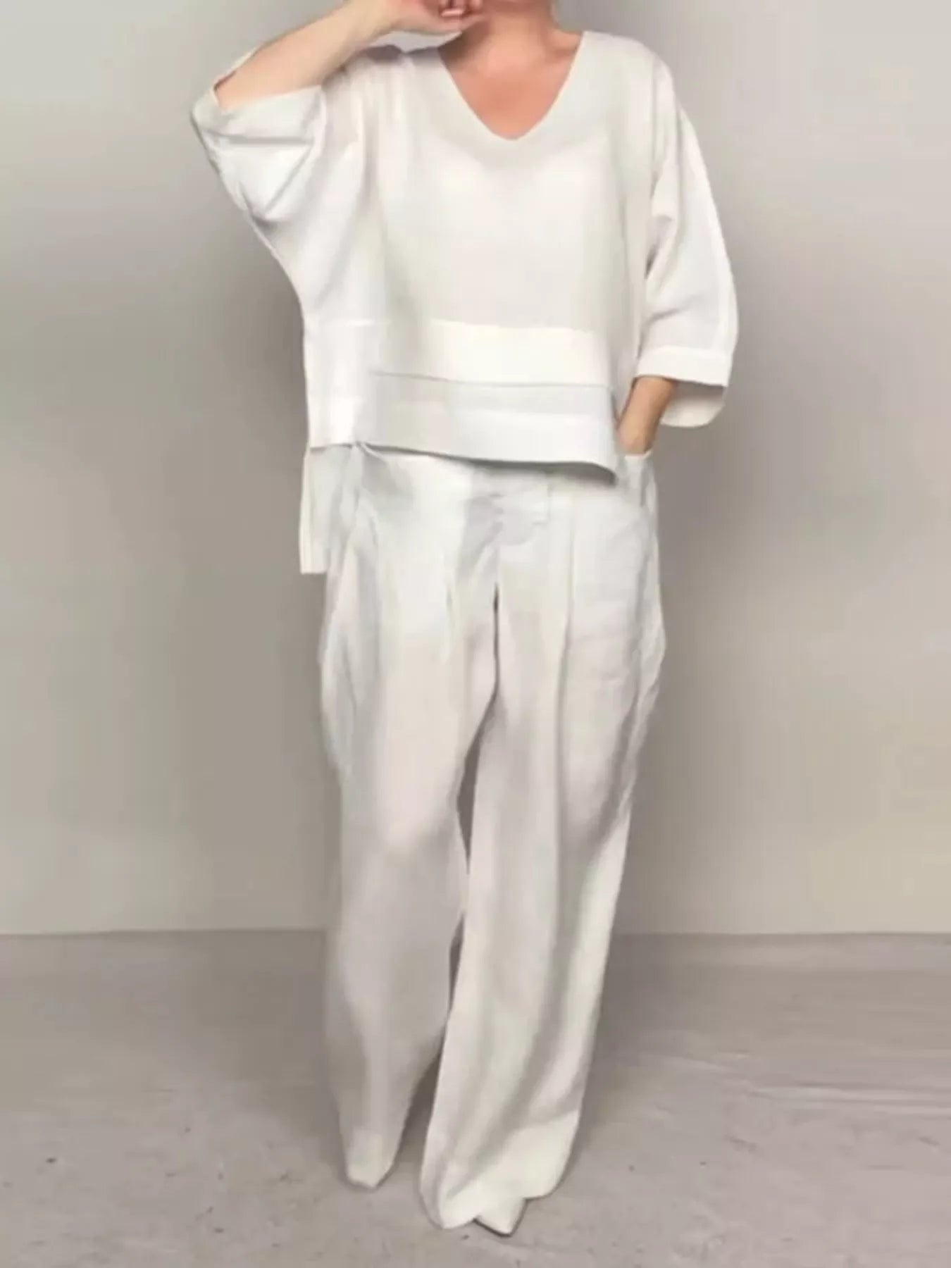 White V-neck long sleeve top and wide-leg pants set, loose fit, cuffed sleeves.