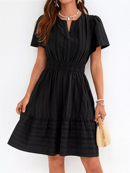 Black short-sleeve smocked waist tiered dress with V-neck and gathered skirt