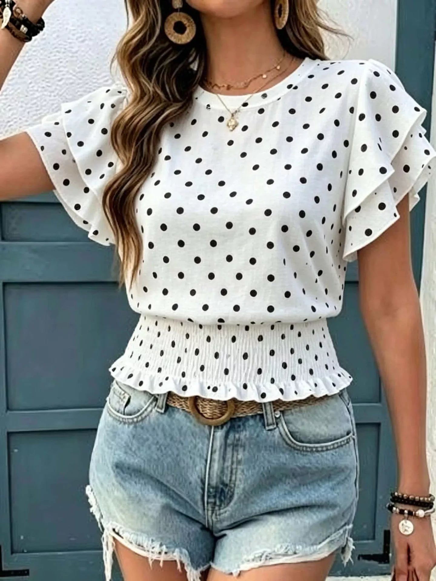 White polka dot blouse with ruffle sleeves and peplum hem