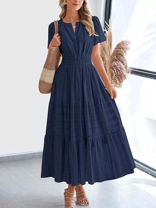 Navy blue tiered midi dress with short sleeves, V-neck, and smocked waist