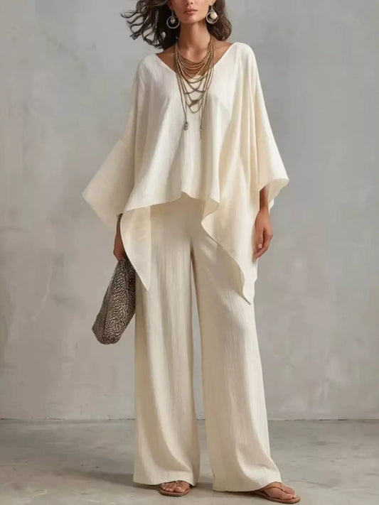 White V-neck top with wide-leg pants set, flowy draped sleeves and asymmetrical hem
