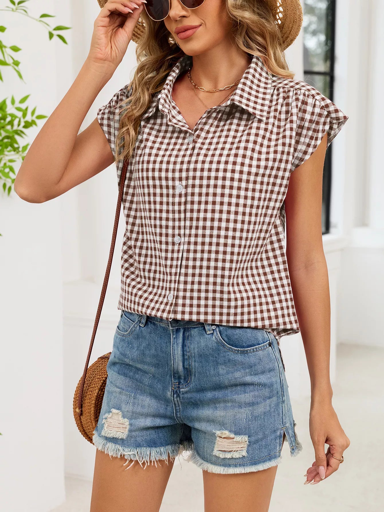 Plaid cap-sleeve button-up shirt in red and white, front view with collar and buttons