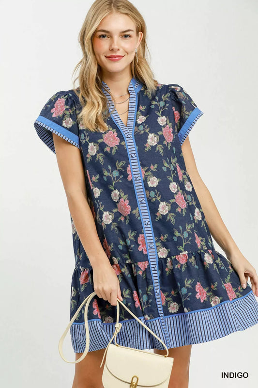 Floral mini dress with indigo base, pink roses, contrast striped trim and ruffle hem
