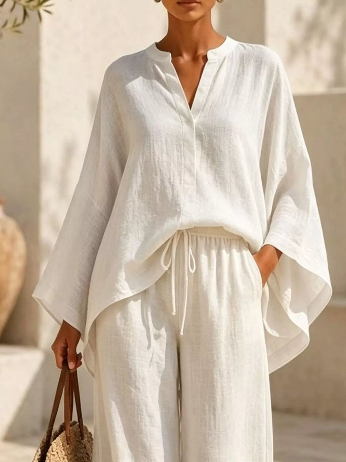 Plus-size notched long-sleeve top and wide-leg pants set in white with V-neck and drawstring