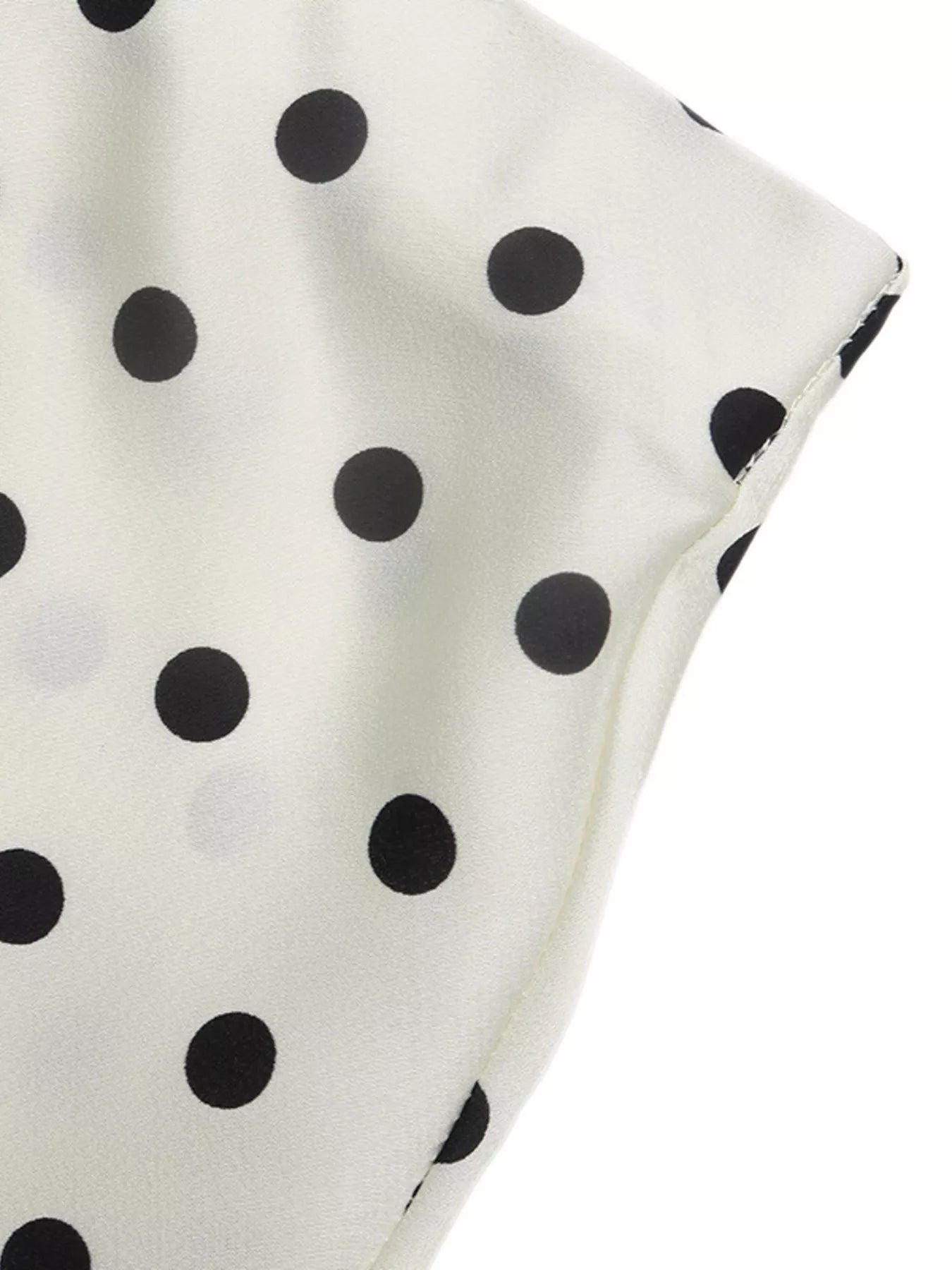 Beige midi skirt with black polka dots and side seam edge detail