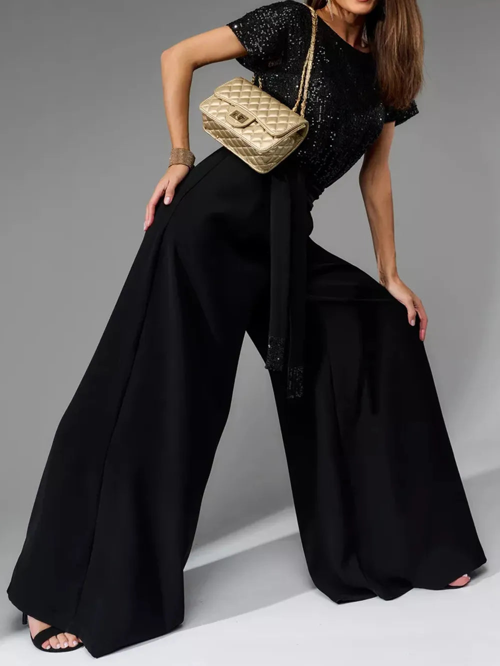 Black sequin short-sleeve wide-leg jumpsuit with belted waist and flowing legs