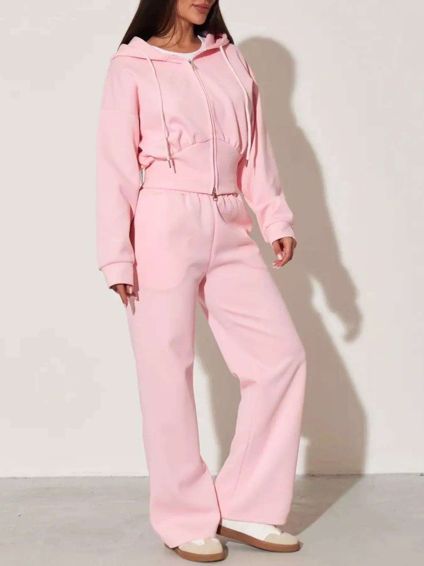 Pink zip-up hoodie and wide-leg pants set, front view with drawstring hood and wide legs